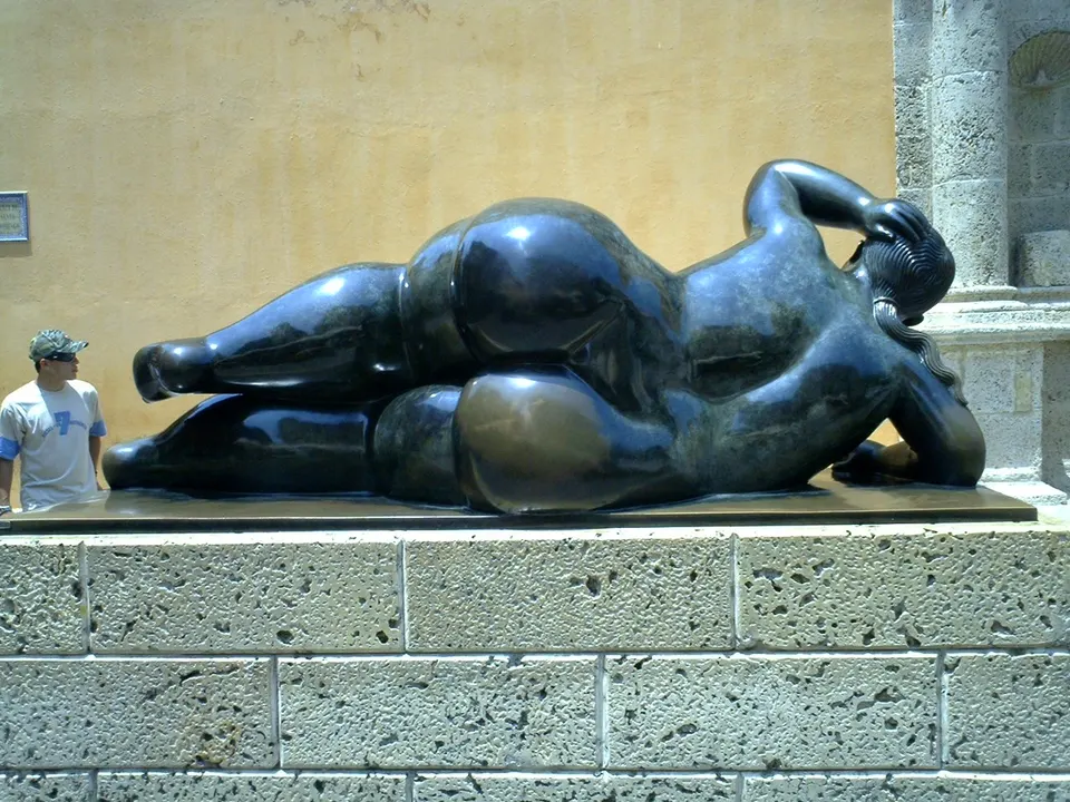 Escultura en bronce de Fernando Botero y mesas al aire libre frente a la iglesia en la Plaza Santo Domingo