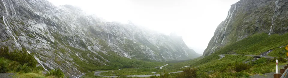 Carretera escénica Milford Road serpenteando por los valles glaciares del Parque Nacional Fiordland.