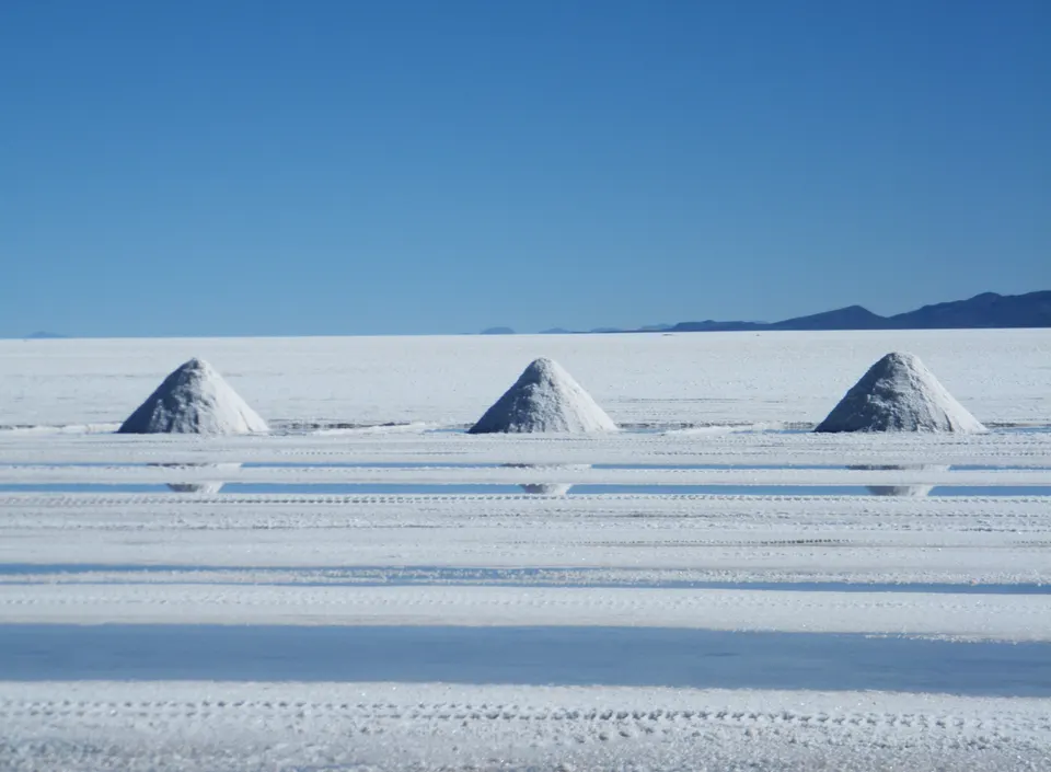 Montículos cónicos tradicionales de sal secándose al sol en Colchani, junto al salar.
