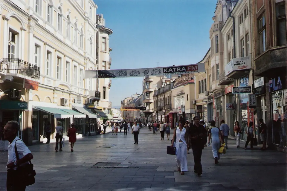 Animada arteria peatonal Knyaz Aleksandar I con edificios modernistas restaurados en Plovdiv.