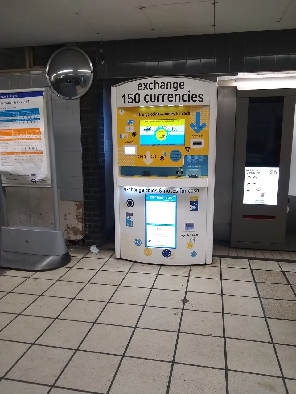 Pequeño puesto callejero de cambio de moneda internacional en una animada avenida turística.