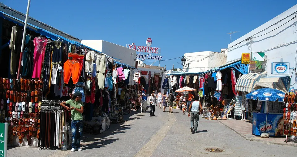 Puestos de especias aromáticas y textiles en el mercado tradicional de la ciudad de Midoun.