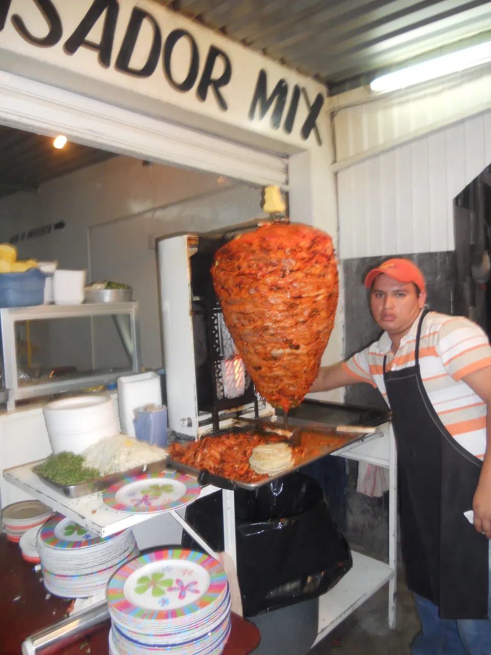 Taqueria de tacos al pastor, toma del "trompo" de donde es cortada la carne para servirla en los tacos, sale el taquero en ciudad-de-mexico