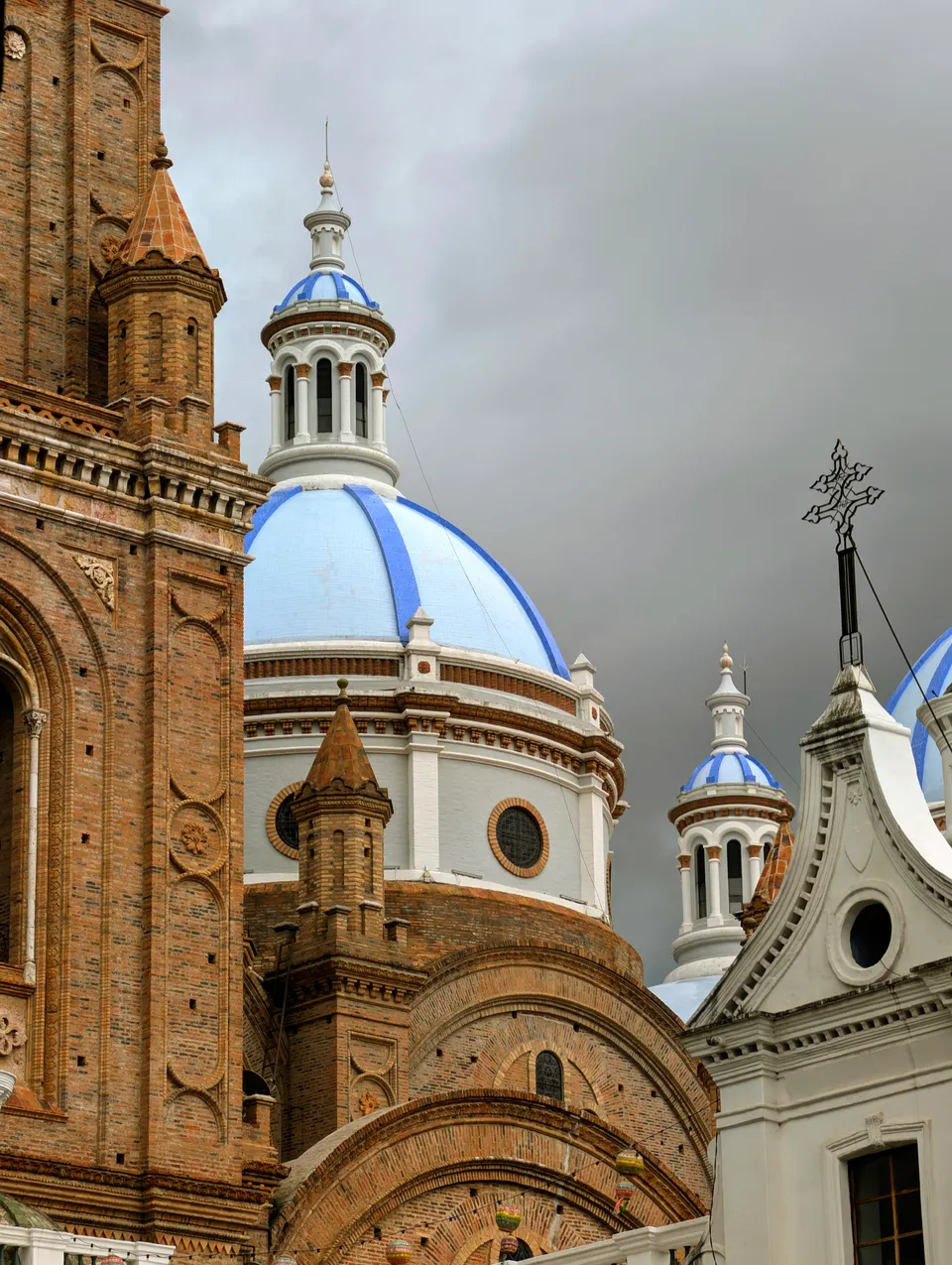 The blue domes (cupolas) of the New Cathedral of Cuenca (Catedral de la Inmaculada Concepción) on a cloudy day, seen nex en cuenca