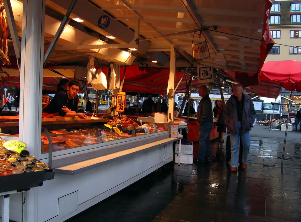 Puestos tradicionales de marisco fresco, salmón y arenques en el mercado Fisketorget de Bergen.